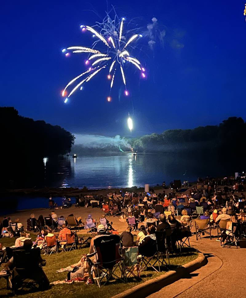 THe crowd watches as a firework reflects off the Rock River at Prophetstown State Park on Saturday, July 6, 2024.