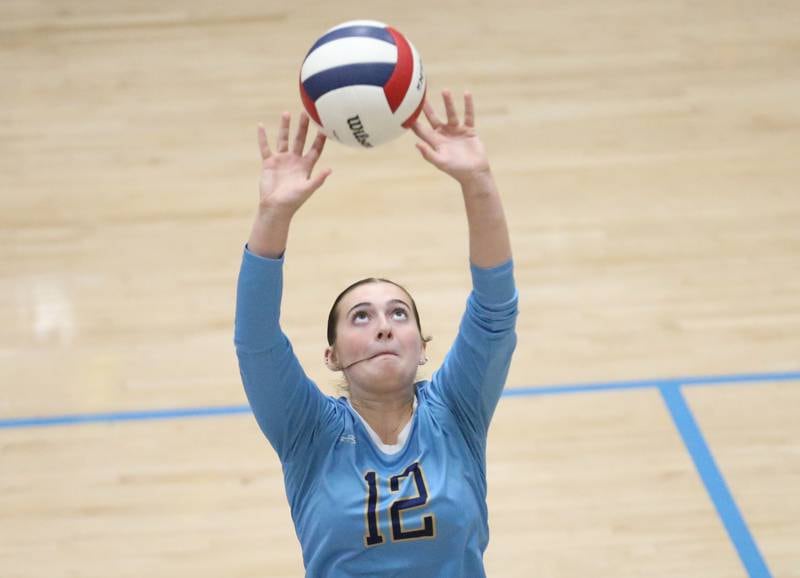Marquette's Kinley Rick sets the ball in play while facing Serena on Wednesday, Oct. 22, 2025 in Bader Gymnasium at Marquette High School.