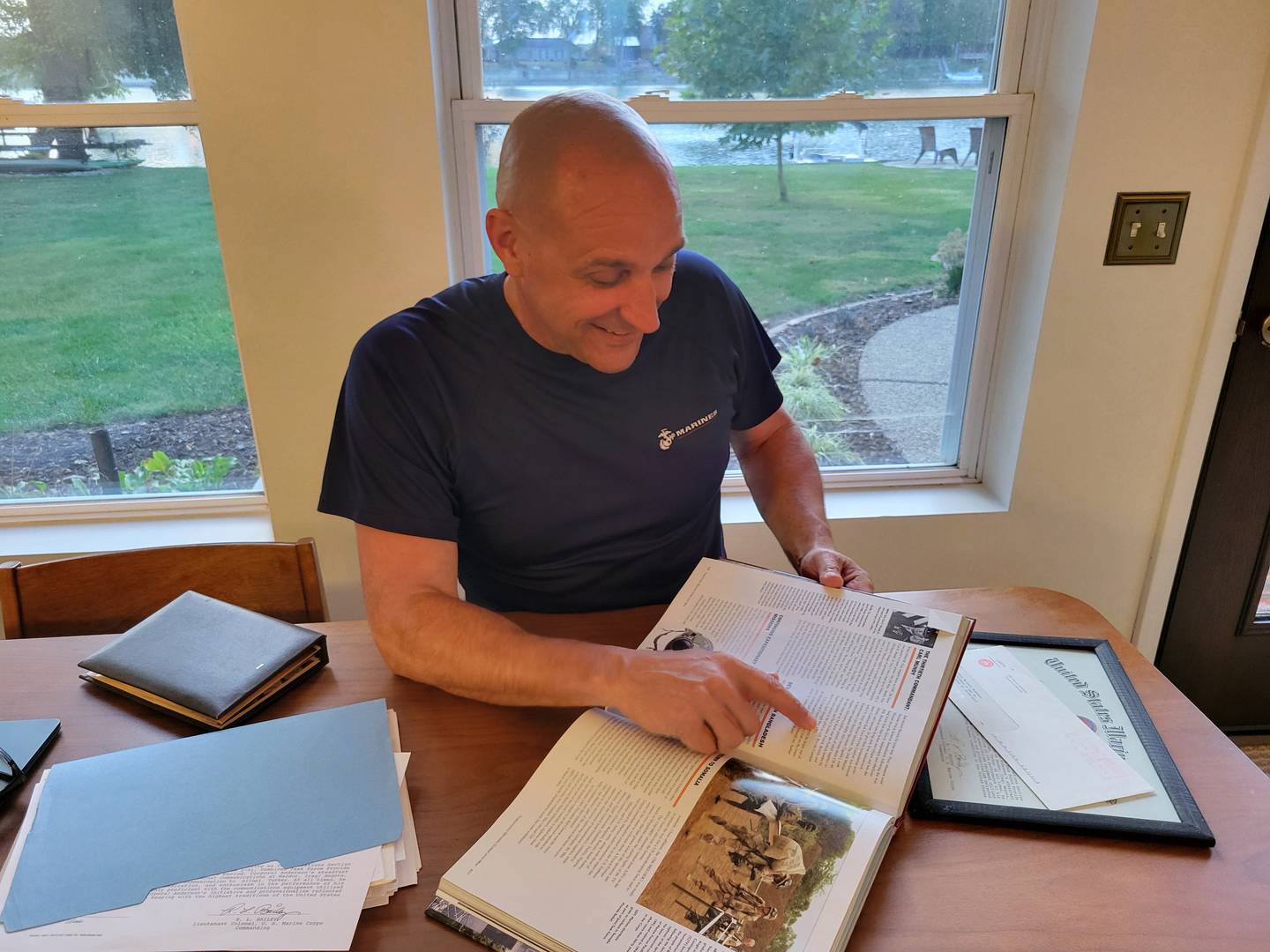 Shannon Anderson points to a paragraph in a history textbook that describes the mission he took part in while serving in the U.S. Marine Corps. His unit's humanitarian mission in Iraq never made news headlines, so he finds the mention particularly special.
