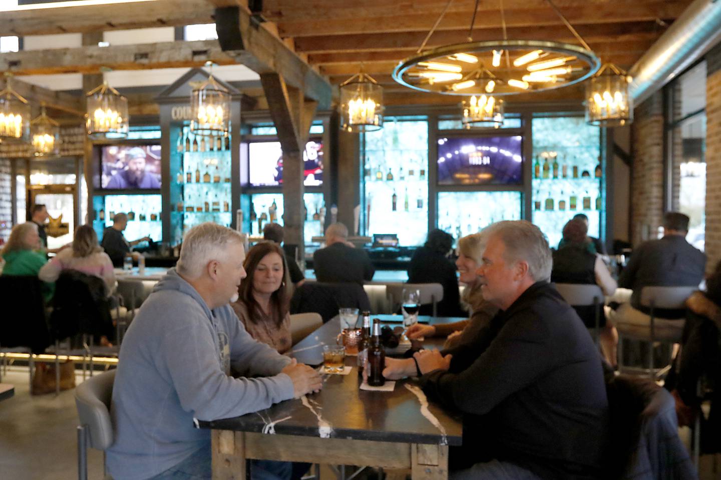 Patrons enjoy drinks and conversation Thursday, April 4, 2024, at the Courthouse Tavern in McHenry. The building was the original McHenry County Courthouse when McHenry was still the county seat.