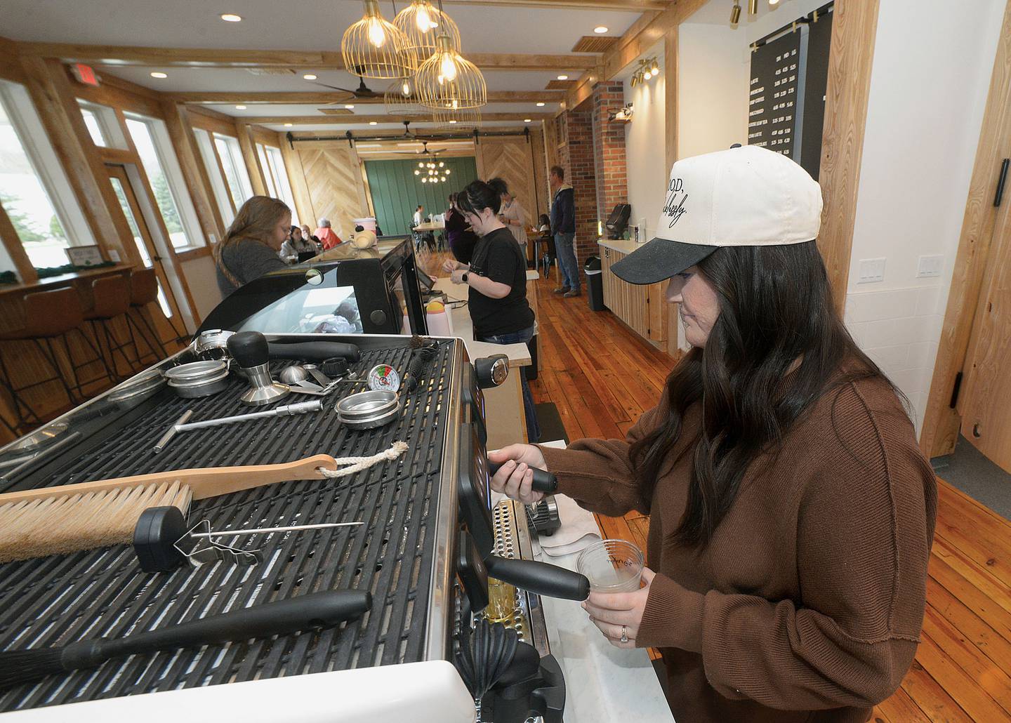 Alyssa Ugolini, owner of Refuge Coffee, prepares a customer's order on April 3, 2025, at her shop inside The Lumberyard building in Seneca.