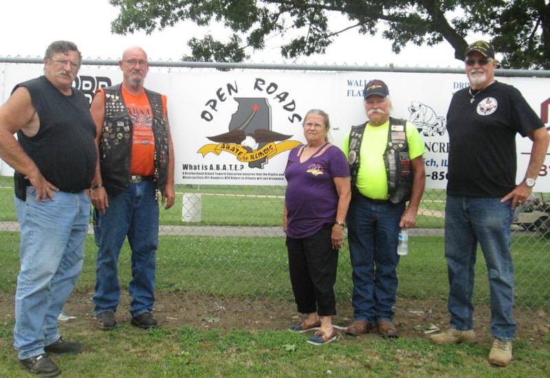 Open Roads ABATE members Bruce Littlebrant, Sam Mataya, Sally Kolb, Cliff Oleson and Bob Mauer are pictured with the sponsor sign at the Midsummer Showdown in Sandwich.