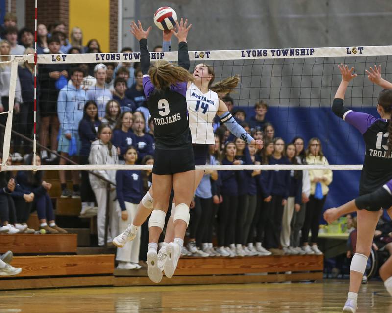 Downers Grove South's Jennifer Curran (14) is met at the net by Downers Grove North's Kelley Crowley (9) during Class 4A Lyons Sectional Semifinal volleyball match between Downers Grove South at Downers Grove North. Nov 4, 2025 in La Grange.
