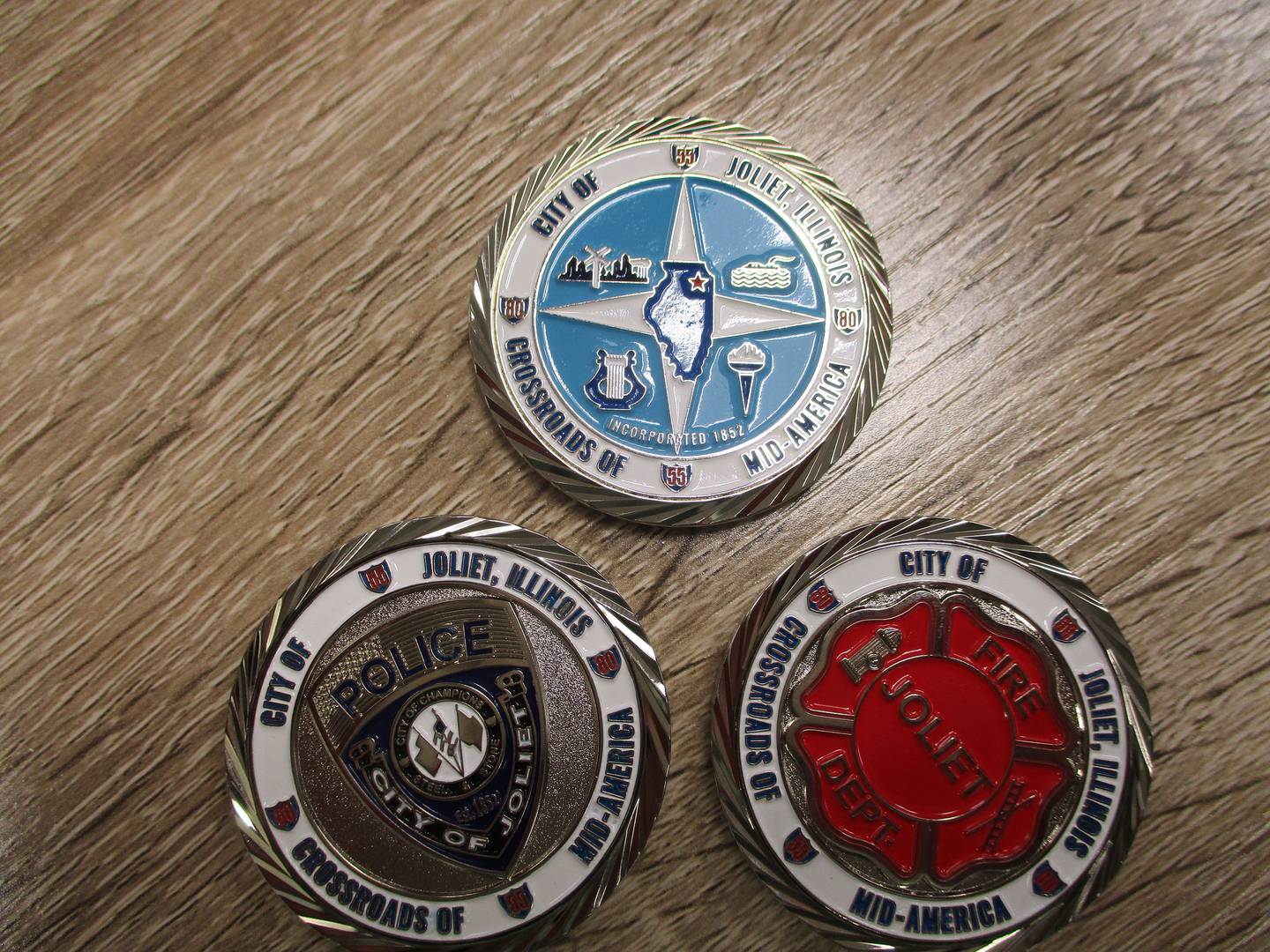 The three Joliet commemorative coins, seen here in March 2022, also include one for the police department and one for the fire department.