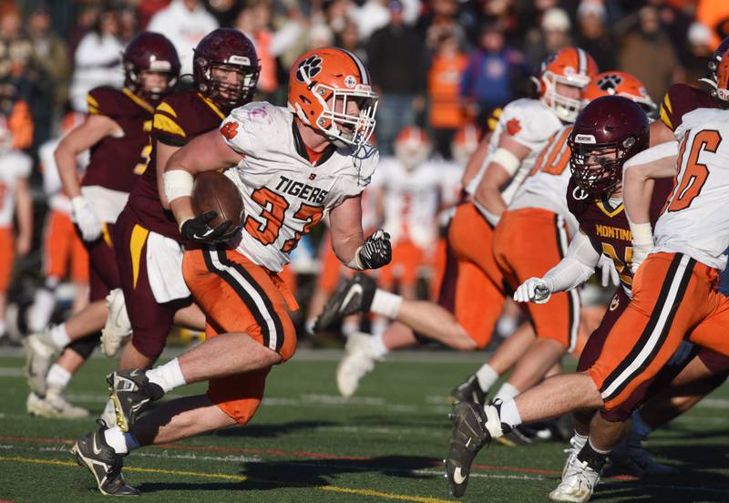 Joe Lewnard/jlewnard@dailyherald.com
Byron’s Caden Considine has the ball after intercepting a Montini pass on fourth down during the fourth quarter of the Class 3A semifinal game in Lombard Saturday.