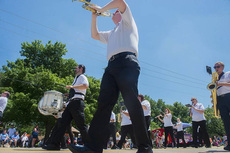 The Dixon Municipal Band leads the Petunia Festival parade through Dixon on Sunday.