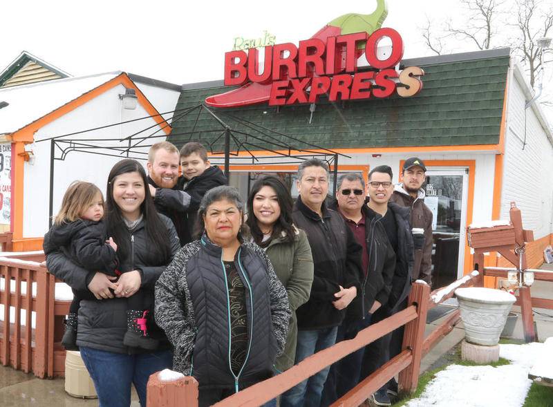 Family members of murder victim Raul Briseno gather Friday outside of Raul's Burrito Express, owned by Briseno's brother Alonso Briseno, (not pictured) in Wauconda. Raul Briseno was killed outside of the Burrito Express he owned in McHenry during an armed robbery on March 6, 2001. Pictured left to right are Raul's daughter Alexandra Strohmaier with her husband Brett and their two children Gia, 1, and Jordan, 5, from Algonquin, Raul's sister Nicole Briseno, of Wauconda, Raul's daughter-in-law Linda Briseno, of Schaumburg, Raul's brother Sergio Briseno, of Island Lake, Raul's brother Paul Briseno, of Barrington, Raul's son Raul Briseno Jr., of Schaumburg, and Raul's nephew Silvestre Briseno of Wauconda.