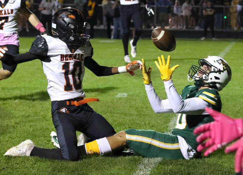 Waubonsie Valley’s Josh Tinney catches a pass behind the defense of DeKalb's Kemari Delgado during their game Friday, Oct. 11, 2024, at Waubonsie Valley High School in Aurora.