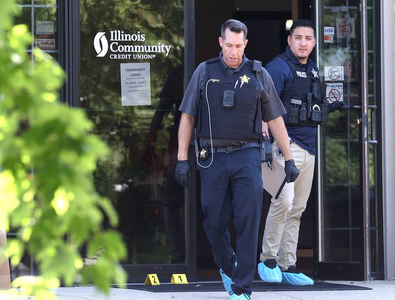 DeKalb Police officers exit the Illinois Community Credit Union Wednesday, July 31, 2024, as they investigate a morning bank robbery in the facility at 1500 Barber Greene Road in DeKalb.