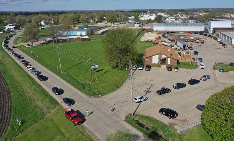 A long line of cars stretching a half-mile long waits to drop off electronics during a free electronics recycling drive on Saturday, April 26, 2025 at the Bureau County Highway Department in Princeton.