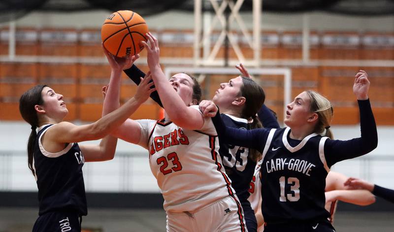 From left, Cary-Grove’s Kennedy Manning, Elizabeth Mjaanes and  Malaina Kurth battle Crystal Lake Central’s Leah Spychala, center, for the ball in varsity girls basketball on Tuesday, Jan. 7, 2025, at Crystal Lake Central High School in Crystal Lake.