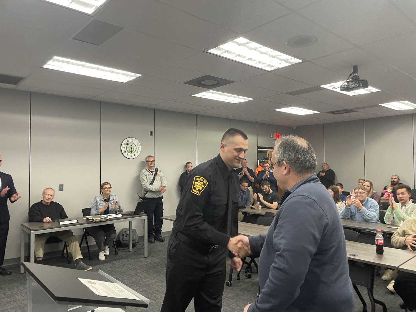 New Mendota police officer Deven Guelde (left) shakes hands with fire and police commissioner Billy Kobilsek at the Mendota City Council meeting on Monday, April 21, 2025. Guelde, who served as a military police officer in the U.S. Army, leaves for the police academy in May and hopes to be behind the wheel of a Mendota police cruiser by year's end.