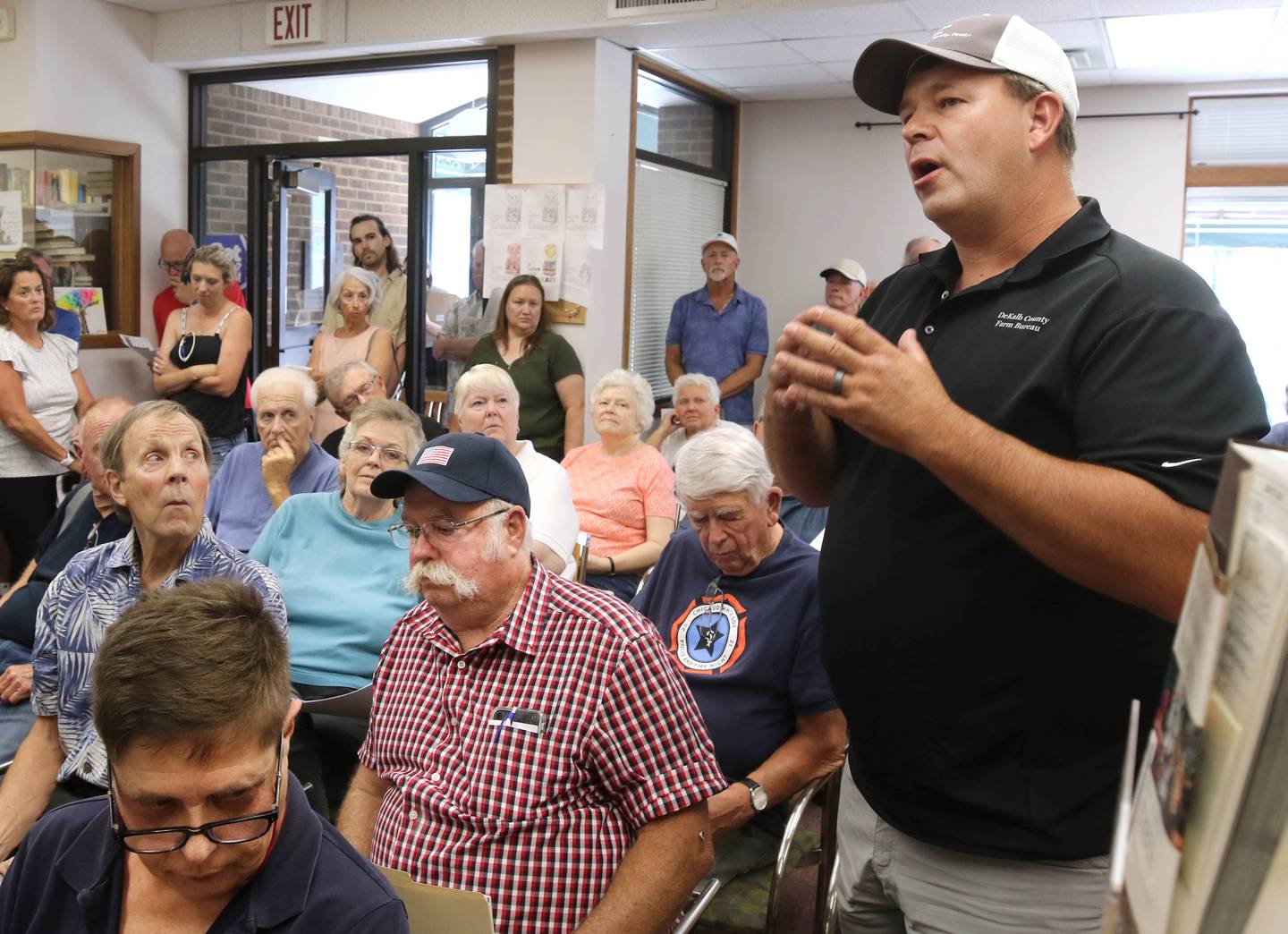 Shabbona resident Berkeley Boehne (right) asks a question at the Flewellin Memorial Library in Shabbona Monday, Aug. 5, 2024, to U.S. Rep. Lauren Underwood, D-Naperville, and Raphael Wahwassuck a tribal council member from the Prairie Band Potawatomi Nation. Underwood and Wahwassuck were on hand for a community conversation regarding the Prairie Band Nation Potawatomi Tribe land transfer in DeKalb County.