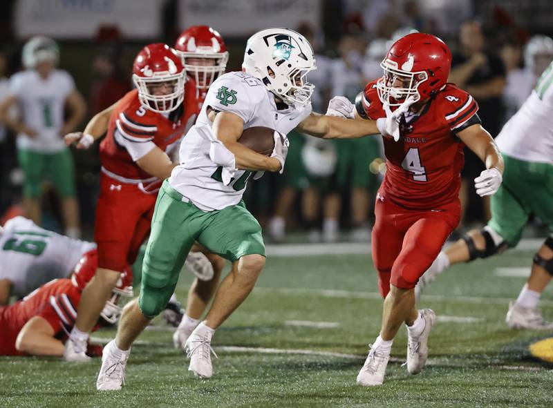 York's Henry Duda (26) tries to evade the York defense during the varsity football game between York and Hinsdale Central on Friday, Oct. 3, 2025 in Hinsdale, IL.