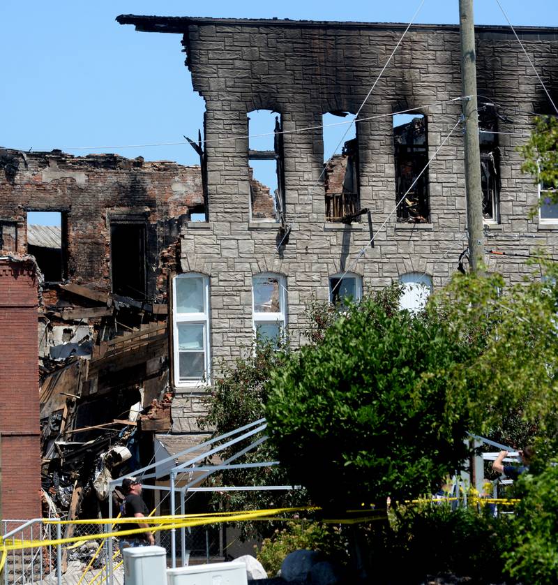 Sterling fire department personnel installed a large MABAS tent on Monday, July 10, 2023, in the Wipfli parking lot across from the charred apartment building at 406 E. Third St. in Sterling. The cause of the fire that destroyed the building on Friday remains under investigation.