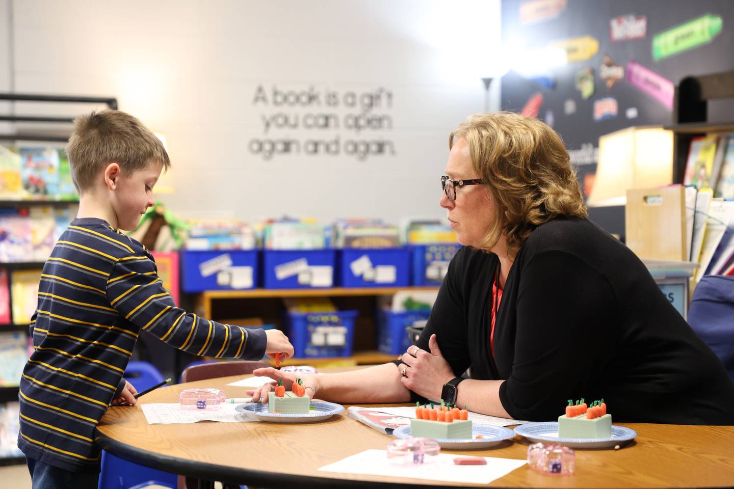 Kindergarten teacher Angela Furgal works with one of her students during class at Grace Christian Academy.