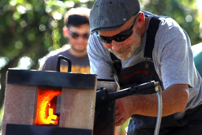 Scott Verseman of Crystal Lake demonstrates a forge as fashions steel crosses during the Johnny Appleseed Festival in Crystal Lake Saturday.