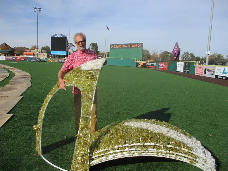 Randy Levy, owner of Glow Holiday Festival, lifts part of an ornament decoration that children will walk through at the holiday event, which runs Nov. 27-Jan. 5 at Slammers Stadium in Joliet. Oct 29, 2024
