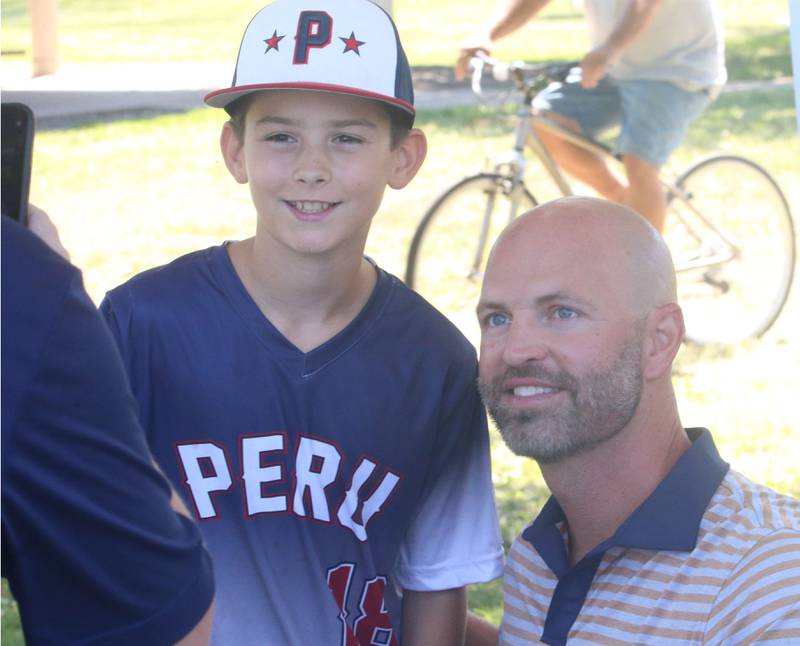 Ayven Michael of Peru, poses with J.A. Happ after signing an autograph during the J.A. Happ Day and field dedication on Sunday, July 30, 2023 at Washington Park in Peru.