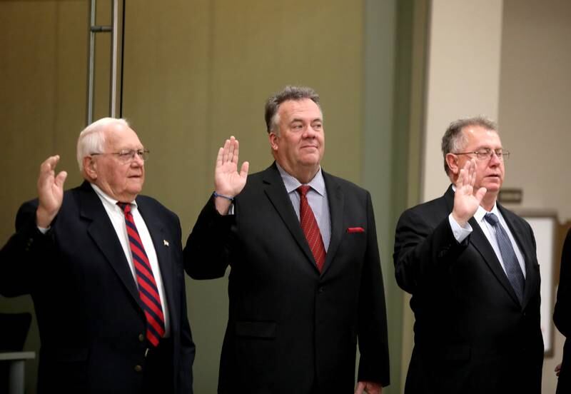 Kane County Board members (from left) Dale Berman, Mark Davoust and Bill Roth take the oath during a swearing in ceremony for newly and re-elected board members at the Kane County Circuit Court in St. Charles on Monday, Dec. 5, 2022.