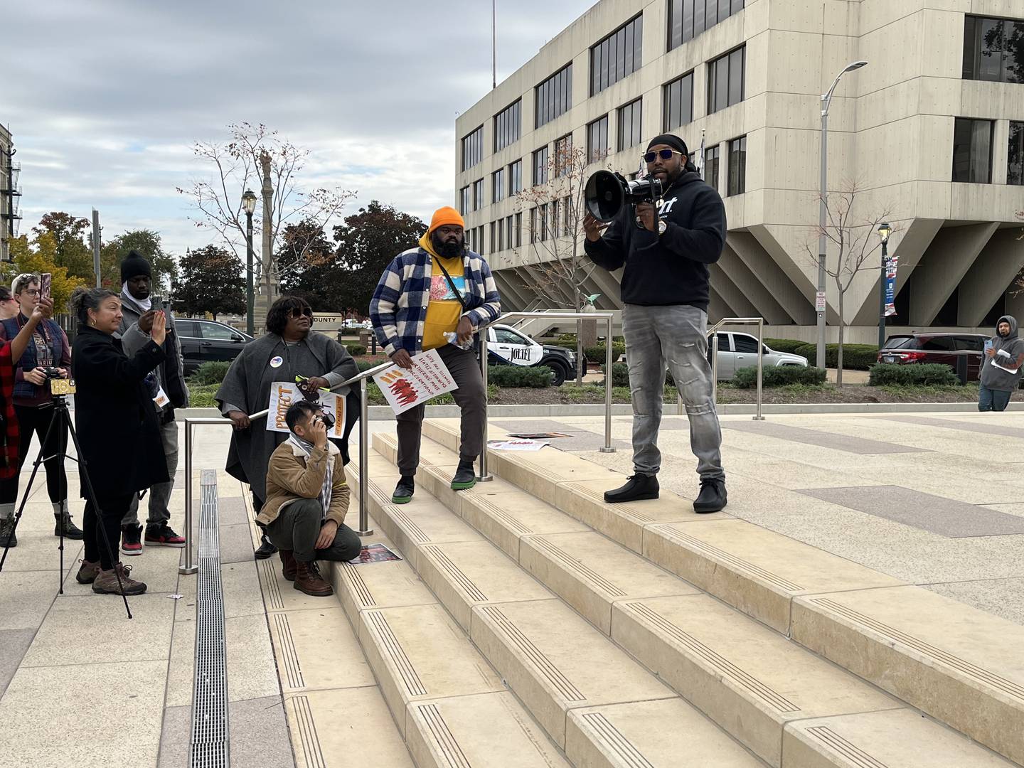 Joliet Township Trustee Karl Ferrell holds a megaphone while speaking to a group of protestors gathered in downtown Joliet near the Will County Courthouse on Thursday, Oct. 20, 2022, in support of the SAFE-T Act.