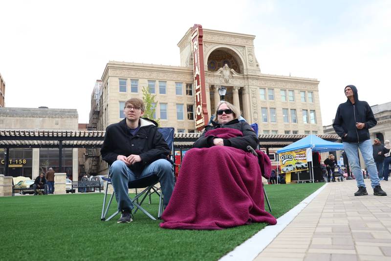 Jakob Scherf and his mom Jenny Scherf , both of Plainfield, get comfy while attending the opening of Joliet's City Square downtown on Friday, May 1, 2026.