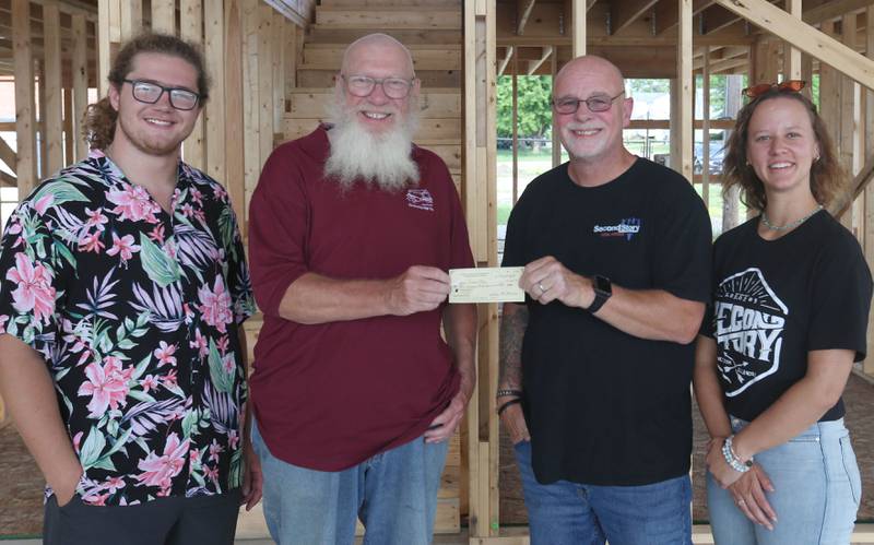 Covered Bridge Barbershop Chorus of Princeton has donated $350.00 to the Second Story Teen Center on Tuesday, July 30, 2024 at the new building in Princeton. Gathered at the check presentation were (from left) Dominic Schillaci, volunteer; Scott Blakeley, barbershop member and director;  Jeff VanAutreve, co-ownera and Asriella Jameson, Program Director of Second Story. Second Teen Second Story Teen Center is a nonprofit 501(c)3 free organization servicing Bureau County as a teen drop in center for two nights per week for youngsters grades 6-12. The center is open Tuesday's from 4p.m.-8p.m. and Friday's  6:30p.m.-11:00 p.m. On average 170 youths per week or just over 8000 youths were served in 2023. Each youth is served free meals and have the opportunity to visit with their friends and enjoy many various games. Through out the year motivational speakers will visit that helps students learn. A food and clothing pantry are  available to all youths. Two post secondary scholarship funds are available to teens seeking post-secondary education at colleges or trade schooling. Construction has begun on a new  6,000 square foot building, located at 125 N. Main St. will increase the capacity for providing numerous educational, mentorship, health, nutritional and social programs for Bureau County youth in sixth through 12th grades. Second Story is funded solely on private donations and the building committee is seeking financial and in-kind donations to invest in the future of the youth of Bureau County and their communities.