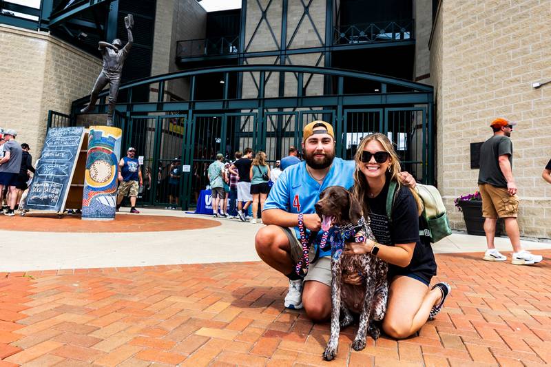 Plainfield residents Joshua and Taylor Bakke pose for a photos with Ruger outside of Duly Heath and Care Field before the Joliet Slammers Dog Day event, presented by University of St. Francis, on Aug. 10, 2025.