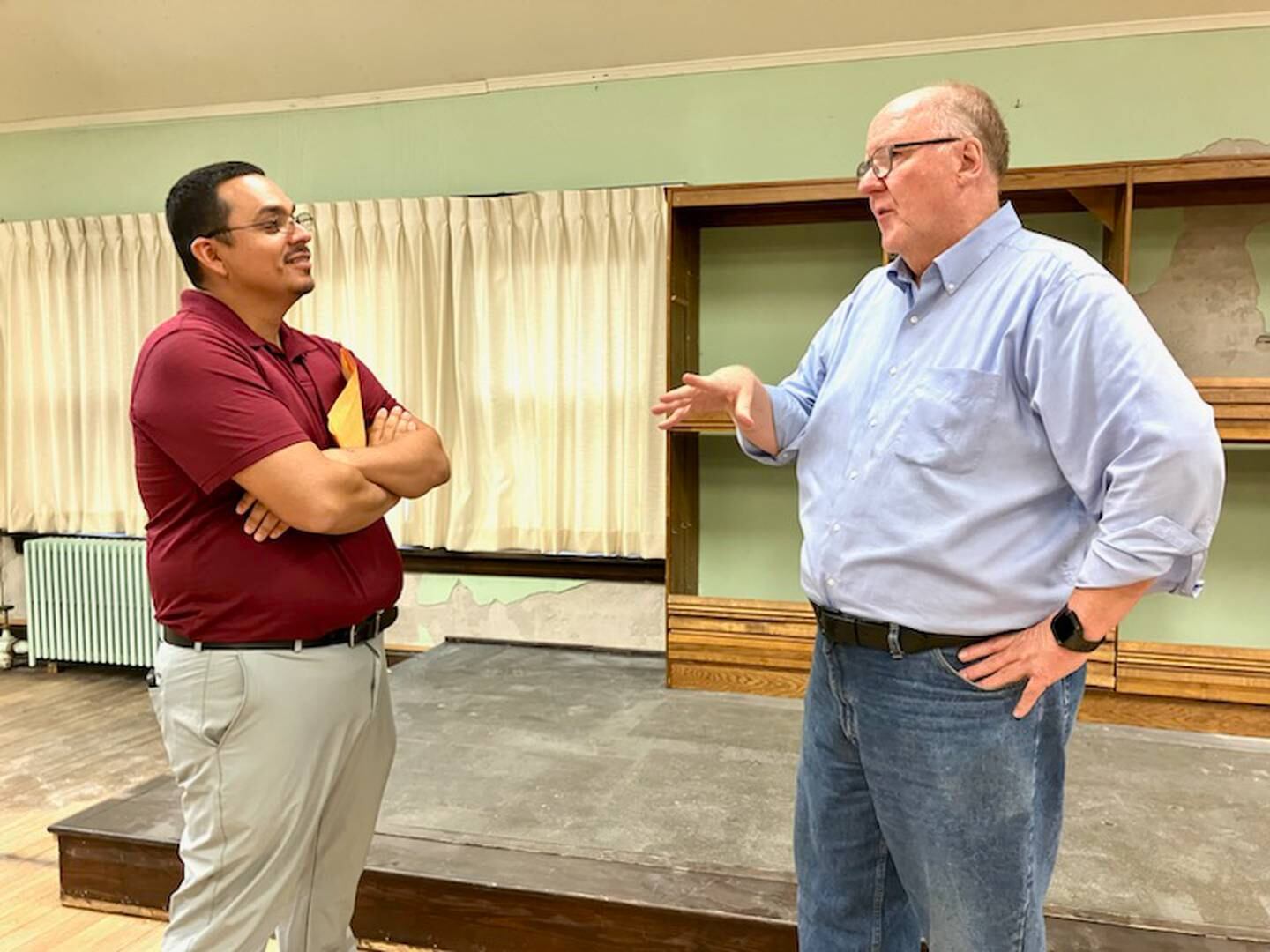 State senate candidate Li Arrelano listens to Bureau County History Center Executive Director Lex Poppens describe Thursday, Aug. 15, 2024, the future plans of the Sash Stalter Matson Building Auditorium.