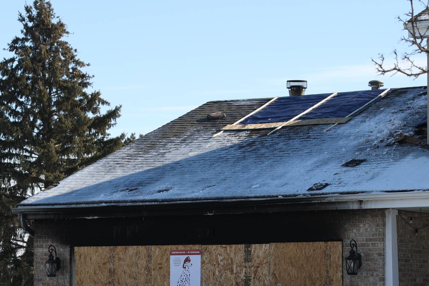 The garage of a home along Quail Drive in Channahon is boarded up after a fire crews were able to contain the structure fire on Monday January 30th, 2023.