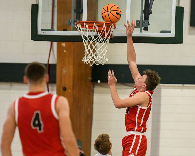 Glenbard East's Sam Walton (24) makes a shot while being defended by Glenbard West's Finn Sheeley (14) on Wednesday Nov. 26, 2025, during the District 87 Thanksgiving Invitational held at Glenbard West High School.