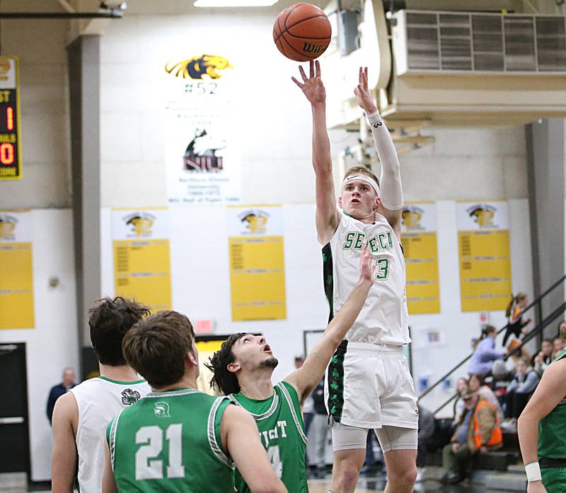Seneca's Paxton Giertz shoots a jump shot over Dwight's Jack Duffy to score a basket during the Tri-County Conference Tournament on Wednesday, Jan. 25, 2023 at Putnam County High School.