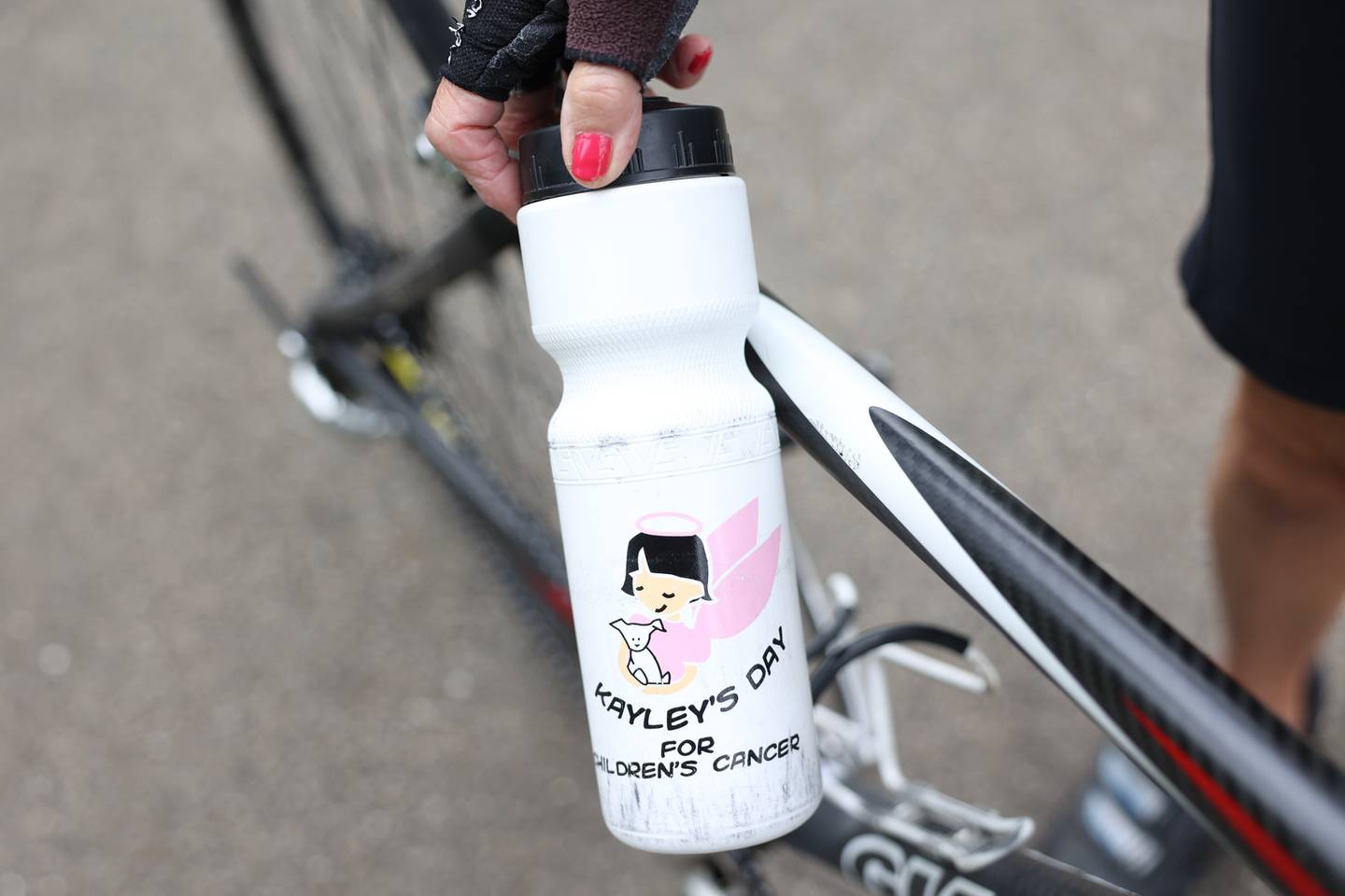 Beverly Voyce shows off a water bottle from a previous fundraiser on Friday, Sept. 23, 2022, in Joliet. Voyce is going to Atlanta, Georgia in October to cycle 30 miles in a fundraiser in memory of her granddaughter who died in 2004 from neuroblastoma.