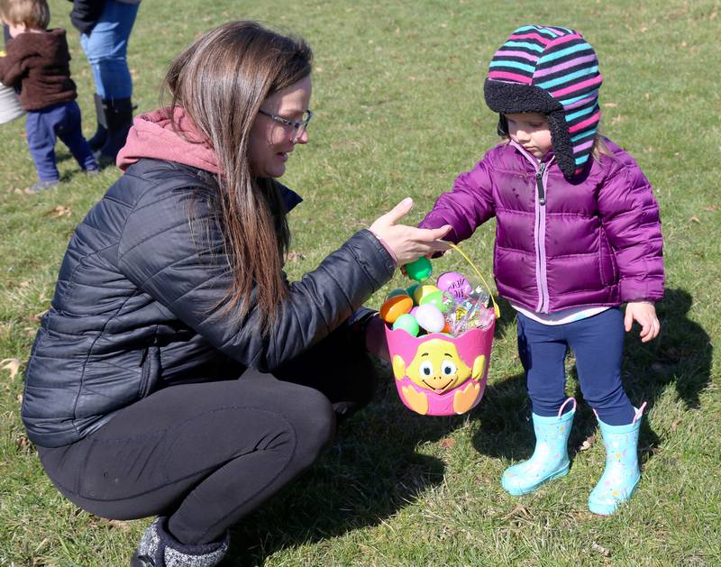 Lillian Michels, 2, of Elburn puts another Easter Egg in her basket at the Easter Egg Hunt at the Lion’s Club in Elburn on Saturday, April 9, 2022.