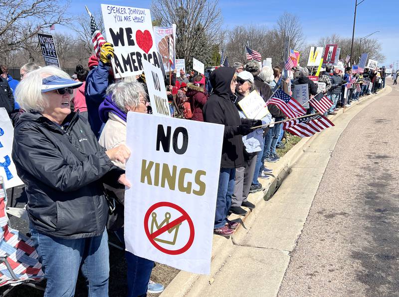 Protesters line Sycamore Road in DeKalb Saturday, March 28, 2026, during a No Kings march and rally against the federal actions of President Donald Trump and his administration.