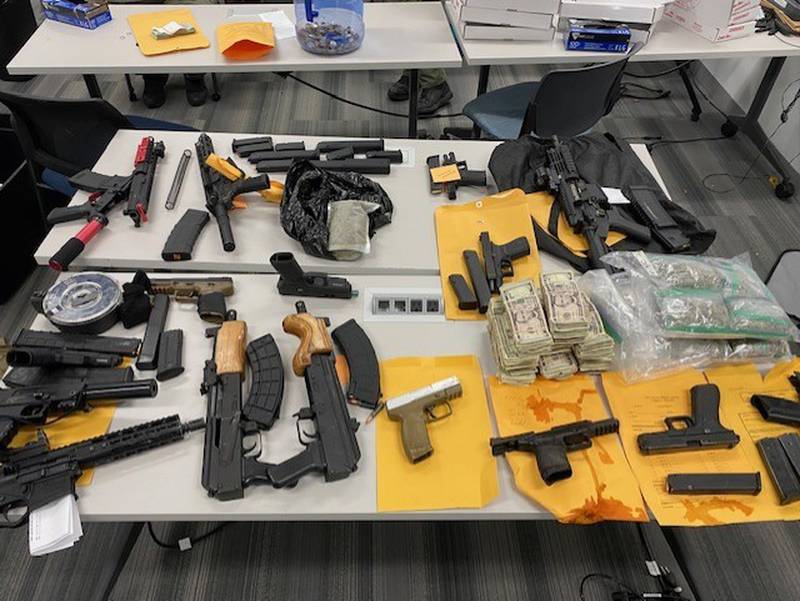 Firearms, drugs and cash seized in a Will County Sheriff's Office investigation that led to the arrest of Ice Heard, Keyson Heard and Devonte Robinson.