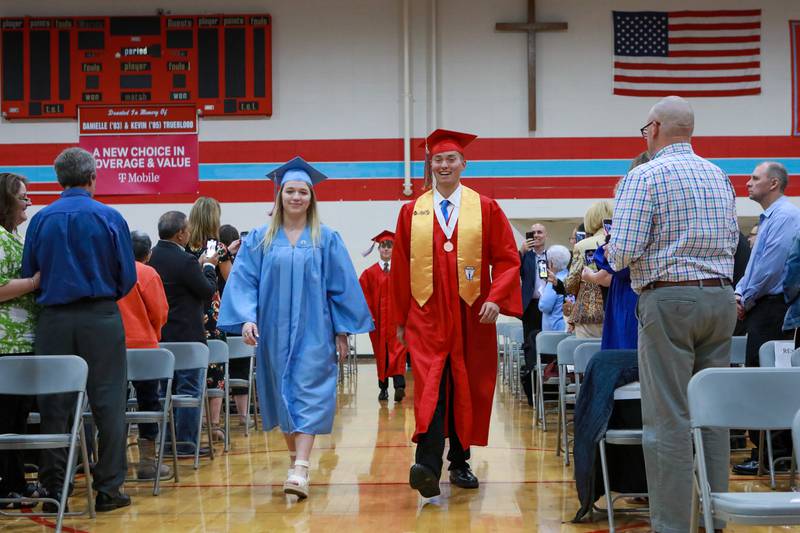 Grace Adams and Matthew Cotting lead the procession into Landers Pavilion for the class of 2022 graduation ceremony Friday, May 27, 2022, at Marian Central Catholic High School in Woodstock.