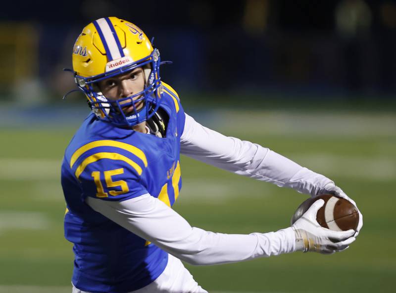 Lyons' Grant Smith (15) runs the ball during the varsity football first-round 8A playoff game between York and Lyons Township on Friday, Oct. 31, 2025 in Western Springs, IL.