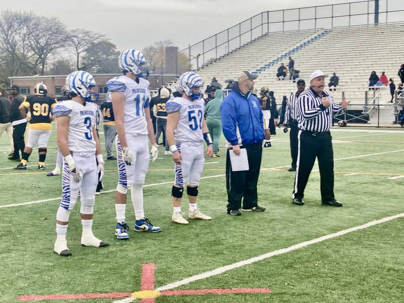 Princeton coach Ryan Pearson and captains Ace Christiansen (3), Noah LaPorte (11) and Ian Morris (52) line up for the captains meeting before Saturday's game at Gately Stadium in Chicago. The Tigers won 34-16 to punch their ticket home for quarterfinals.