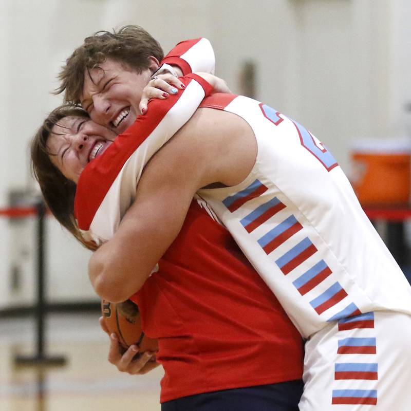 Marian Central’s Christian Bentancur hugs his mother, Elizabeth, after scoring his 2,000 point during a nononference boys basketball game against Marengo on Tuesday, Feb.13, 2024, at Marian Central High School.