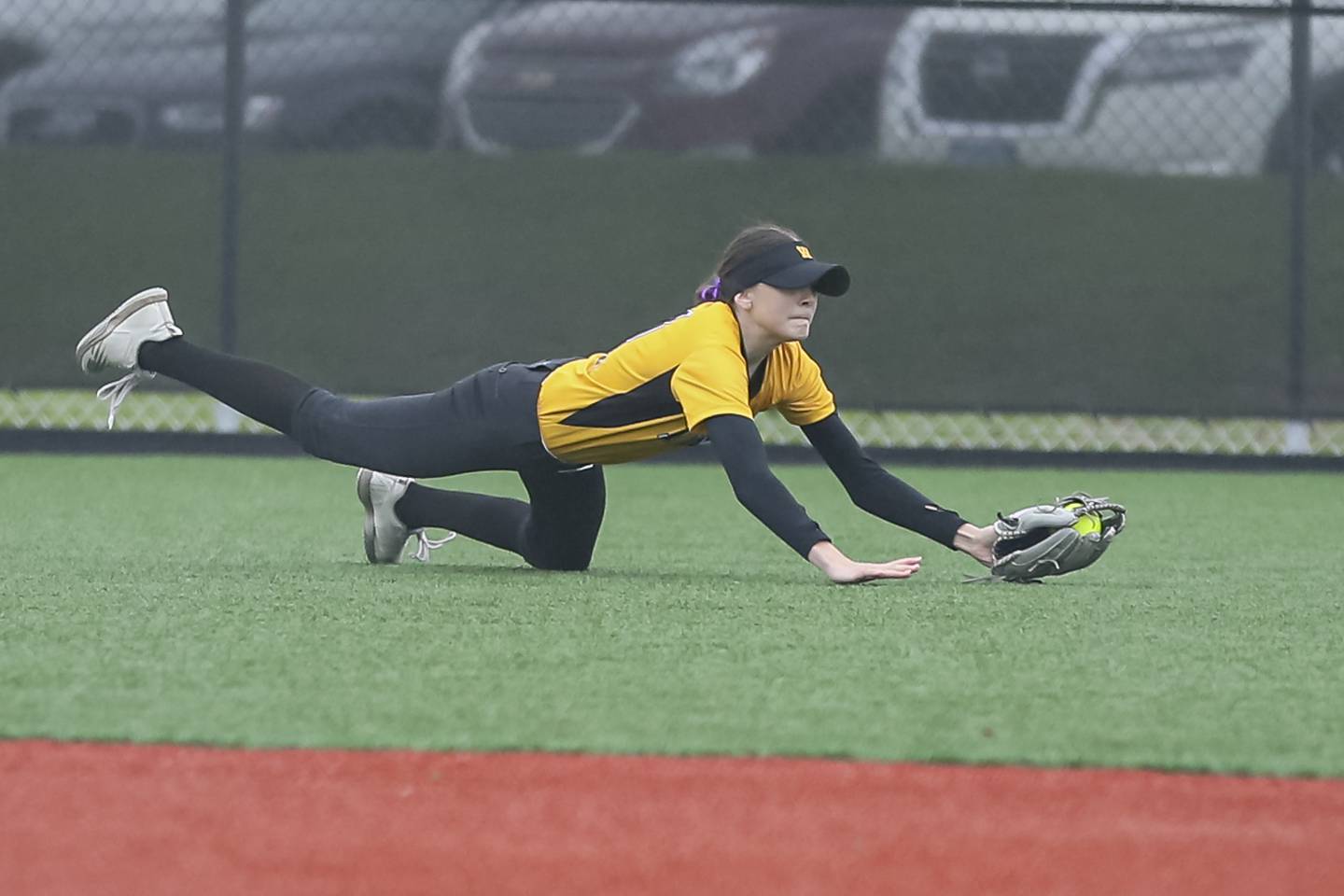 Joliet West's Caitlin Jadron (11) makes a diving catch during softball game between Joliet West at Yorkville on Wednesday, April 30, 2025 in Yorkville.