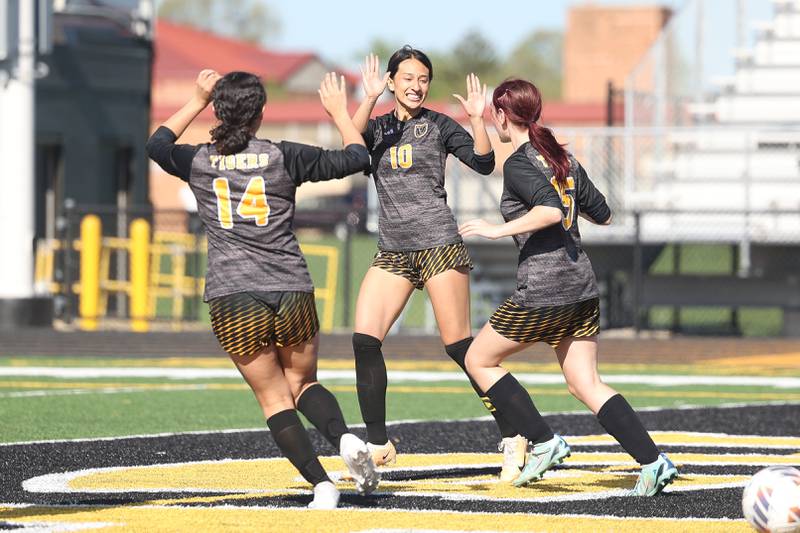 Joliet West’s Julia Martinez, 10, is greeted by teammates after scoring in the first minute of the game against Joliet Central on Tuesday, April 30, 2024.