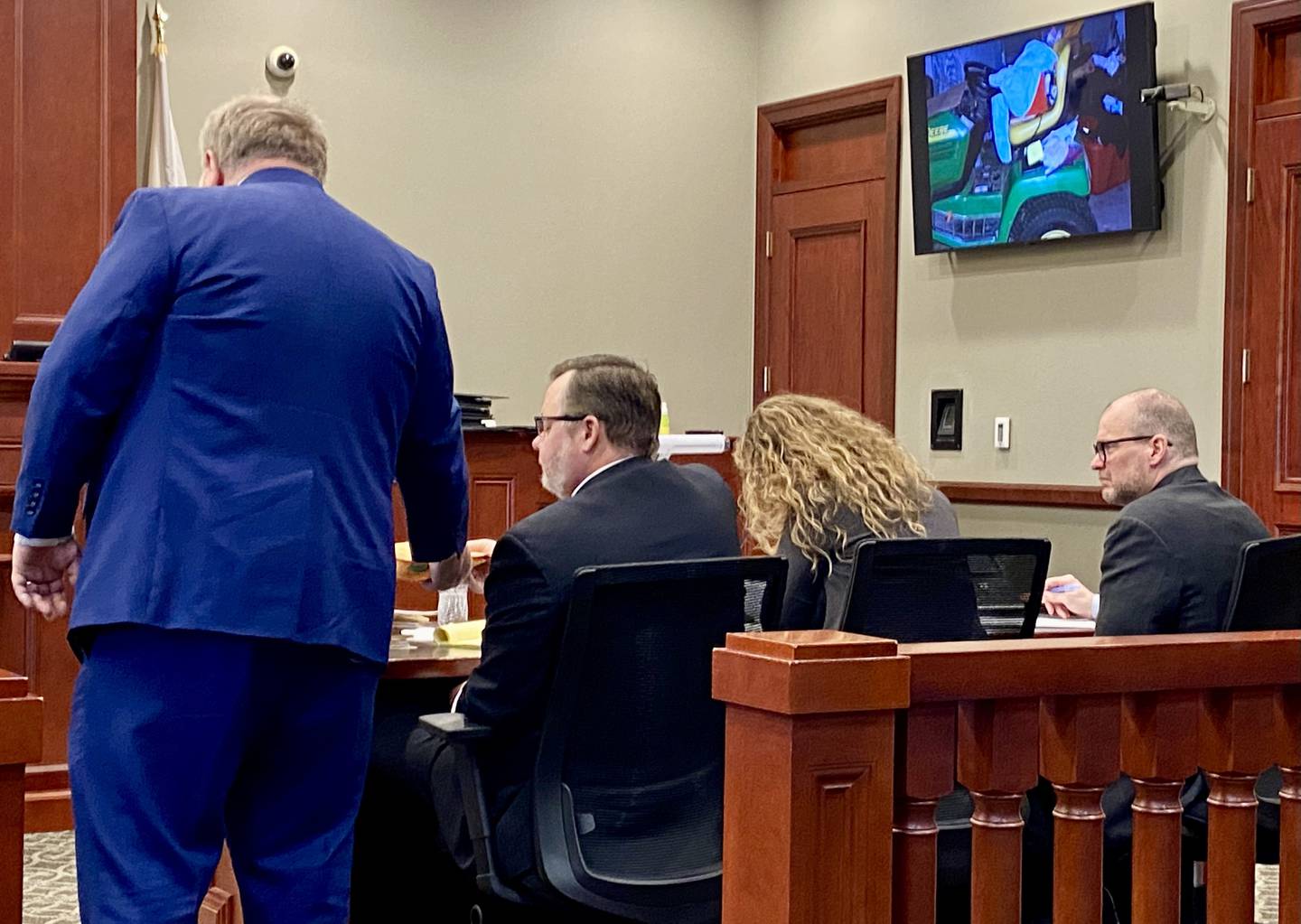 Jonathan D. Hurst (right), 55, formerly of Chicago, looks on as prosecutor Brooks Locke (left) shows crime scene photographs for evidence to Hurst's defense attorneys, public defenders Chip Criswell and Emma Franklin. Prosecutors with the DeKalb County State's Attorney's Office called law enforcement witnesses on Friday, Jan. 24, 2025, to testify about crime scene processing during the second day of Hurst's criminal trial at the DeKalb County Courthouse. Hurst is charged with murder in the 2016 killings of Patricia Wilson and her son Robert Wilson in Sycamore.