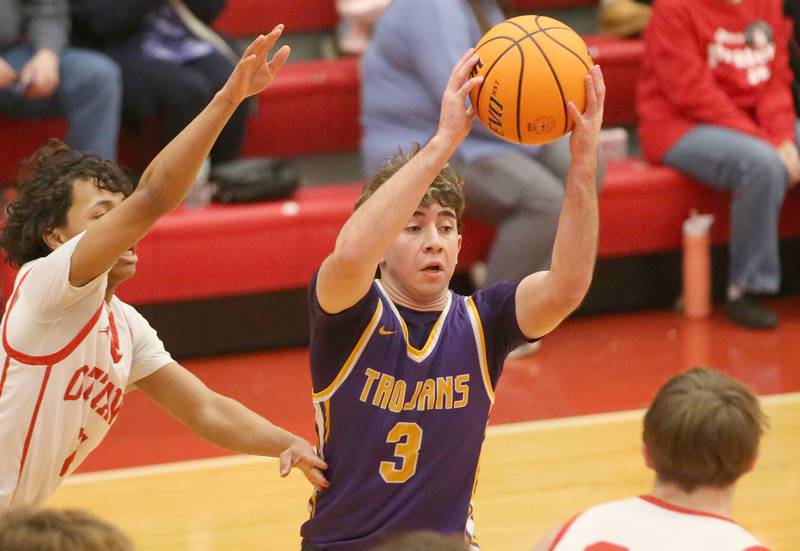 Mendota's Cam Kelly looks to pass the ball around Ottawa's Hezekiah Joachim on Tuesday, Jan. 7, 2025 in Kingman Gym at Ottawa High School.