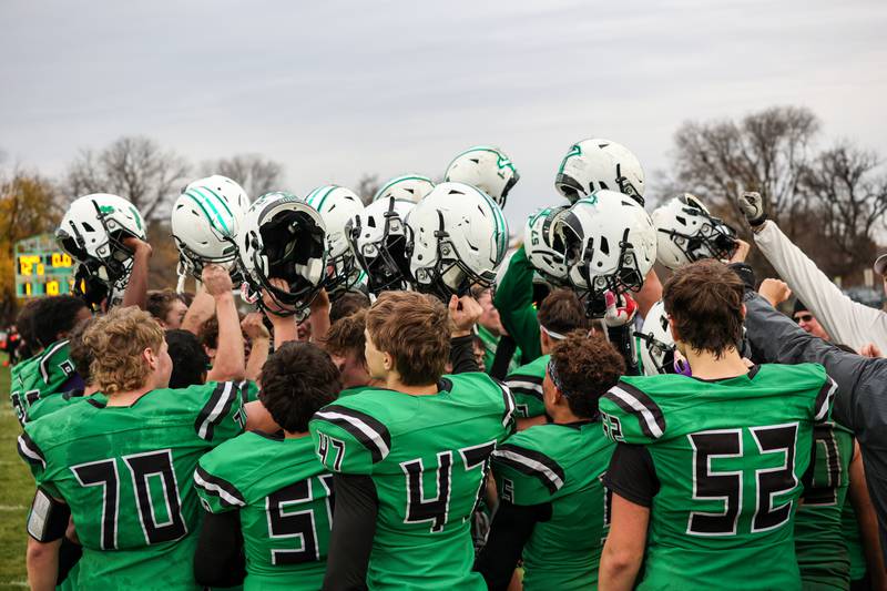 Players of Dwight/Gardner-South Wilmington hold up helmets in celebration of win on Saturday, November 9, 2024 at Dwight High School in Dwight.
