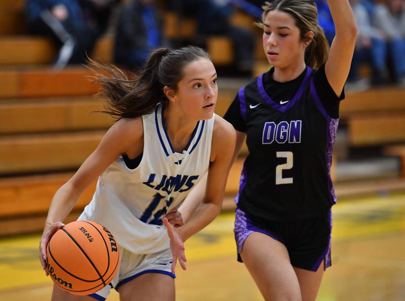 Lyons Township’s Sydney Munson drives as Downers Grove North’s Eva Yerkovich (2) defends during a game on January 10, 2026 at Lyons Township High School in LaGrange.