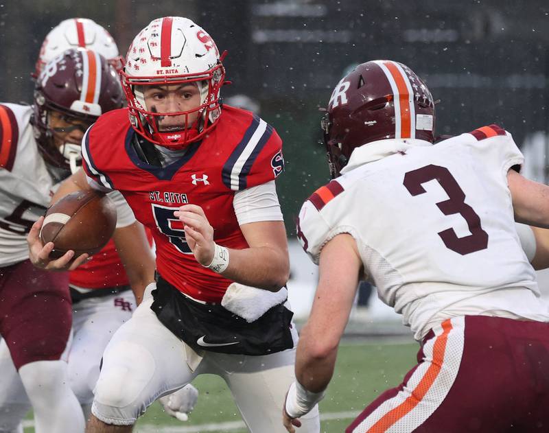 St. Rita's Steven Armbruster looks to get by Brother Rice's Michael Fitzgerald Wednesday, Dec. 3, 2025, during their IHSA Class 7A state chamionship game in Huskie Stadium at Northern Illinois University in DeKalb.