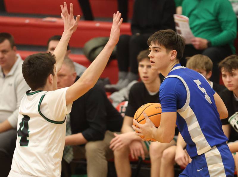 Princeton's Jack Oester looks to pass the ball around Eureka's Connell Roth during the Colmone Classic on Thursday, Dec. 11, 2025 at Hall High School.