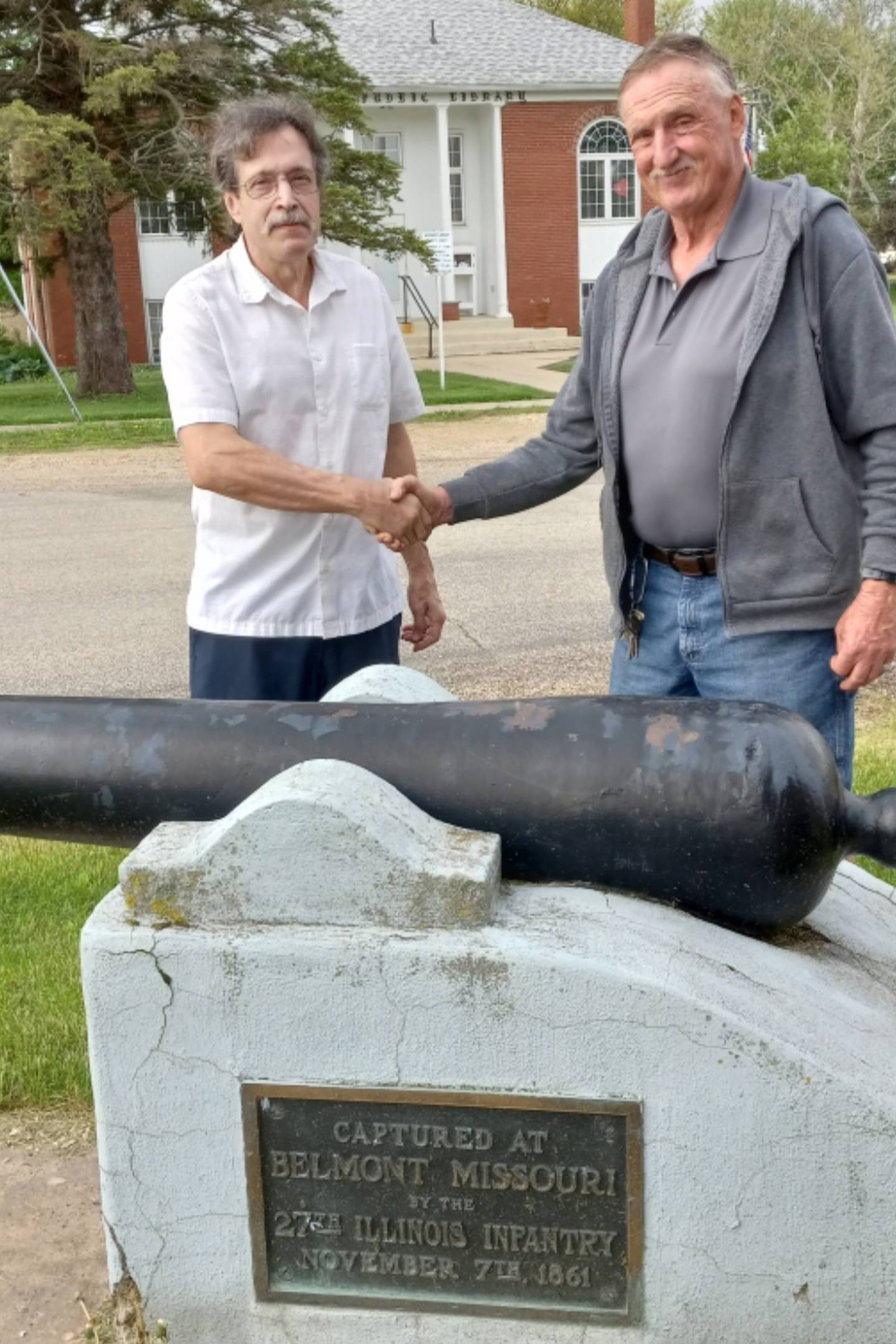 Tom Bailey, Historical Ordinances Works, Georgia and Gary Miller, Neponset Legion post commander discuss a restoration of their civil war cannon.