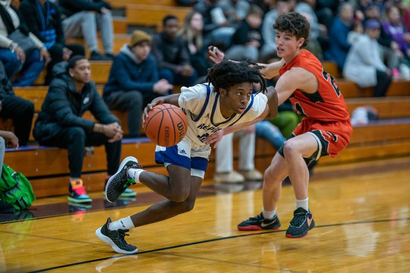 Plano's Davione Stamps (10) drives past Sandwich’s Evan Gottlieb (24) during a basketball game at Plano High School on Friday, Jan 20, 2023.